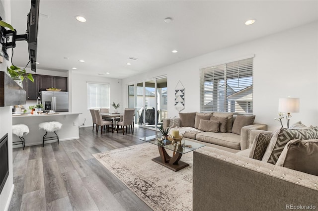 living room with recessed lighting and wood finished floors