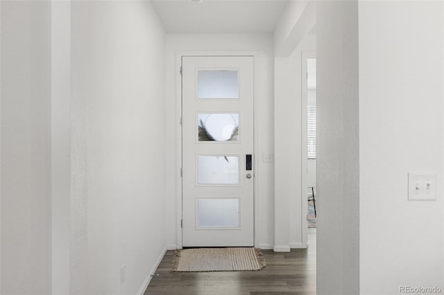 interior space featuring wood finished floors and baseboards