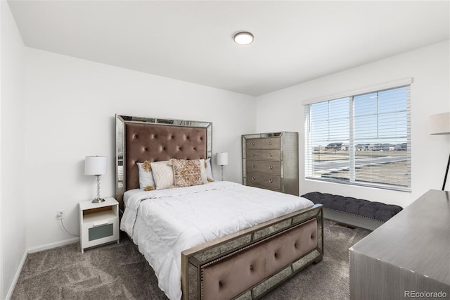 bedroom featuring dark colored carpet, visible vents, and baseboards