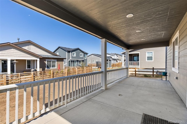 view of patio / terrace with fence and a residential view