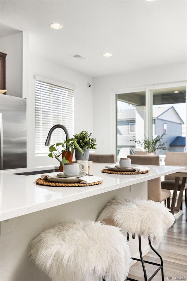 interior space featuring recessed lighting, visible vents, and wood finished floors