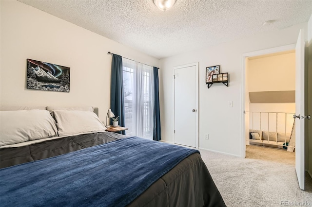 carpeted bedroom with baseboards and a textured ceiling