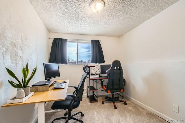 home office featuring light carpet, baseboards, and a textured ceiling