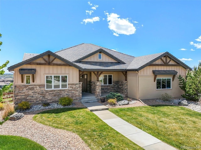 9510 Orion Way, Arvada, CO 80007 - craftsman-style house featuring stone siding, a front yard, and board and batten siding