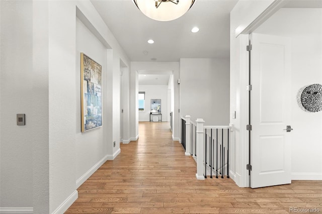 9510 Orion Way, Arvada, CO 80007 - hall with light wood-style floors, recessed lighting, an upstairs landing, and baseboards