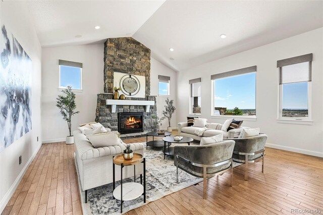 9510 Orion Way, Arvada, CO 80007 - living room featuring light wood-style flooring, a fireplace, baseboards, high vaulted ceiling, and recessed lighting