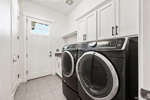 9510 Orion Way, Arvada, CO 80007 - laundry area featuring separate washer and dryer, cabinet space, light tile patterned flooring, and baseboards