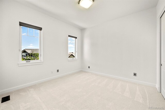 9510 Orion Way, Arvada, CO 80007 - spare room featuring light colored carpet, plenty of natural light, and baseboards
