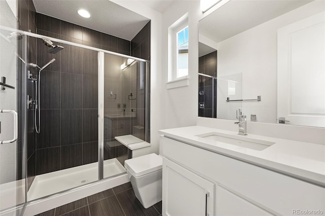 9510 Orion Way, Arvada, CO 80007 - full bathroom with toilet, vanity, a stall shower, and recessed lighting
