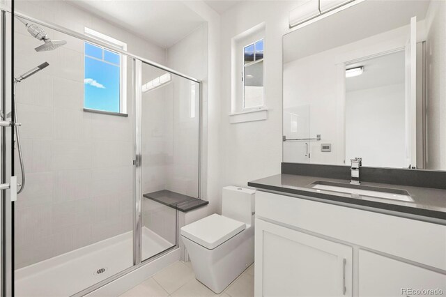 9510 Orion Way, Arvada, CO 80007 - bathroom with a stall shower, vanity, toilet, and tile patterned floors