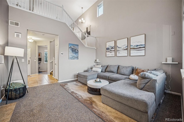 living room featuring light colored carpet, a high ceiling, and a notable chandelier