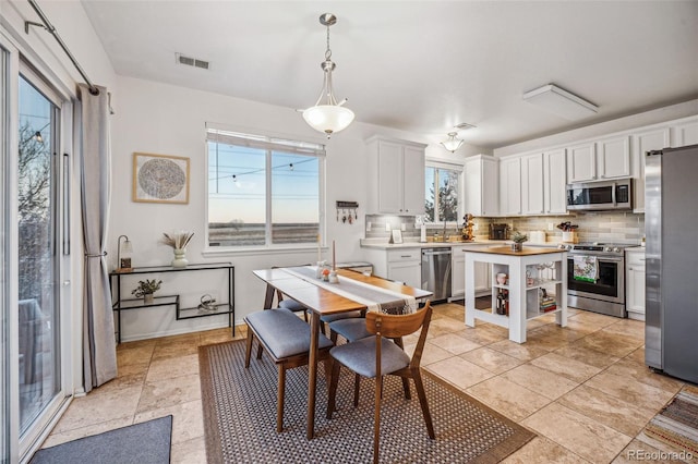 tiled dining room with sink