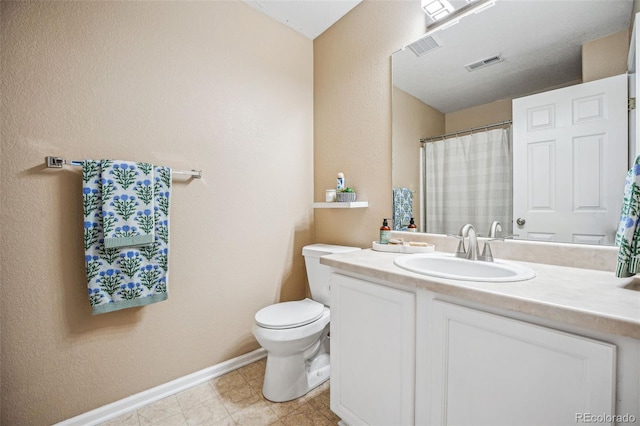 bathroom with toilet and vanity