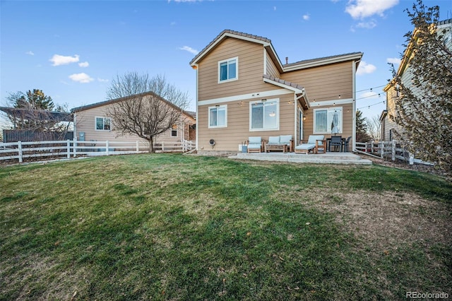 back of house featuring a lawn and a patio