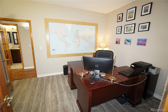 home office with wood finished floors and baseboards