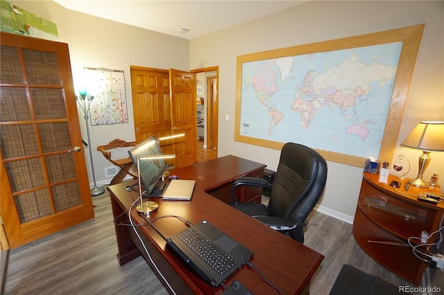 office featuring baseboards and wood finished floors