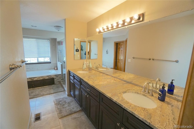 full bath featuring a bath, tile patterned floors, visible vents, and a sink