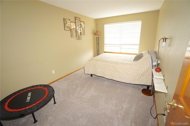 bedroom with carpet and baseboards