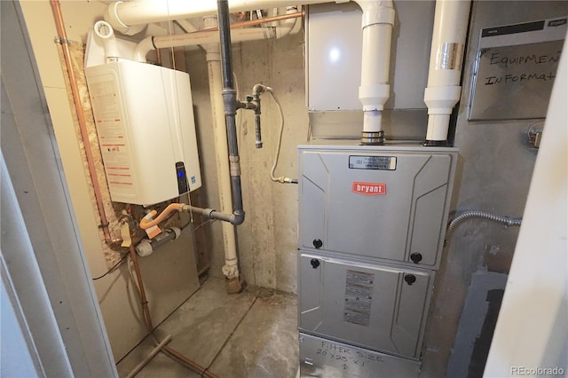 utility room with heating unit and water heater