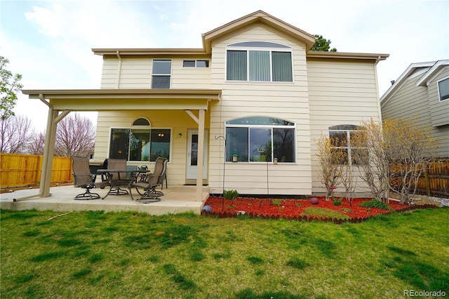 back of house featuring a patio area, a lawn, and a fenced backyard