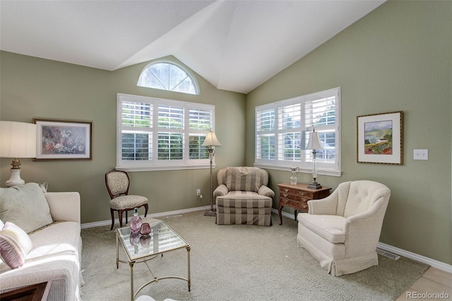 sitting room featuring lofted ceiling, carpet, plenty of natural light, and baseboards