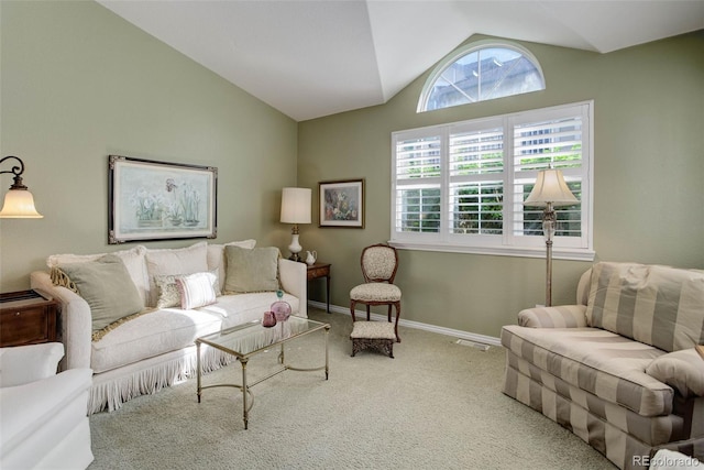 carpeted living room with lofted ceiling, visible vents, and baseboards