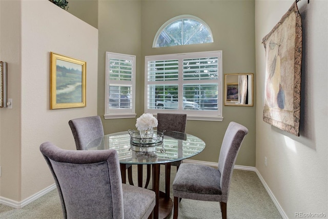 dining space featuring carpet and baseboards