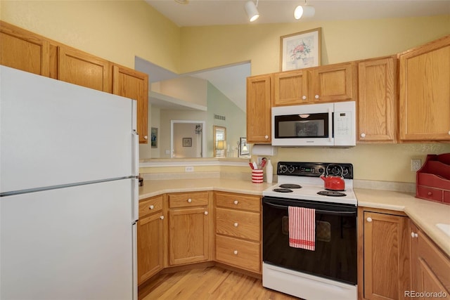 kitchen with white appliances, light wood finished floors, visible vents, lofted ceiling, and light countertops