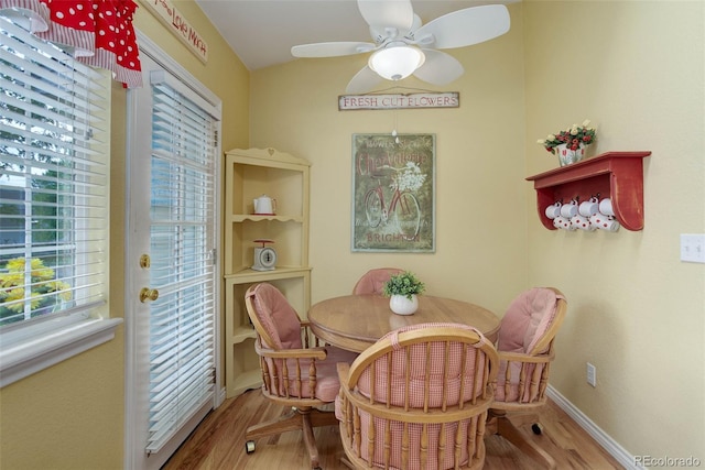 dining room with baseboards, a ceiling fan, and wood finished floors