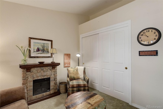 sitting room featuring carpet and a fireplace