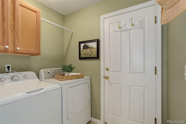 laundry area featuring washing machine and dryer and cabinet space