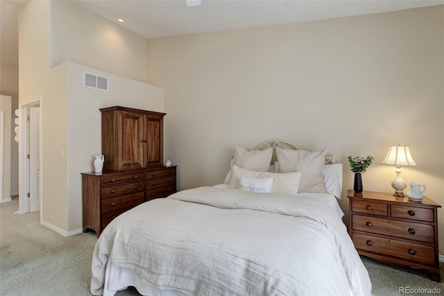 bedroom with light carpet, high vaulted ceiling, baseboards, and visible vents