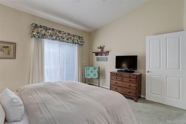 bedroom with light carpet and baseboards