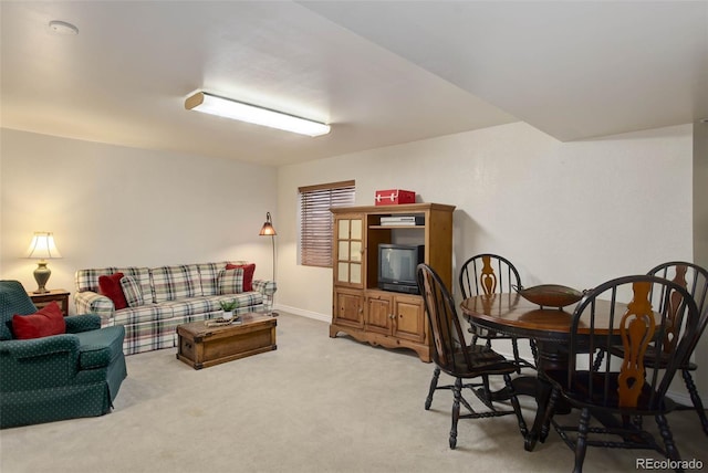 living area featuring baseboards and carpet flooring