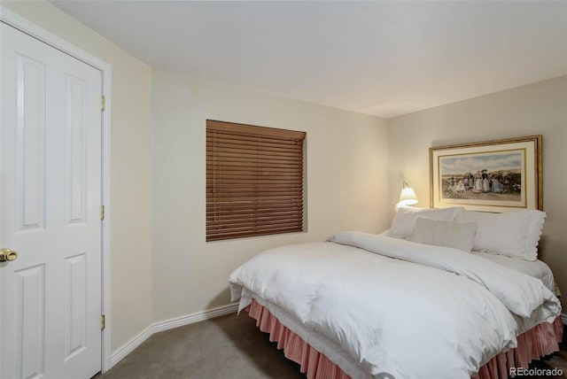 carpeted bedroom featuring baseboards