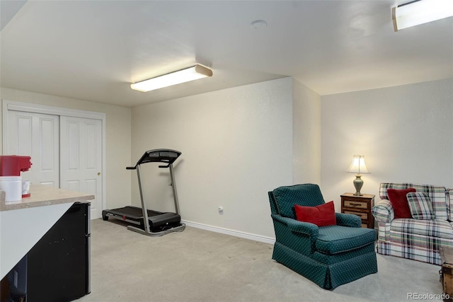 sitting room featuring baseboards and light colored carpet