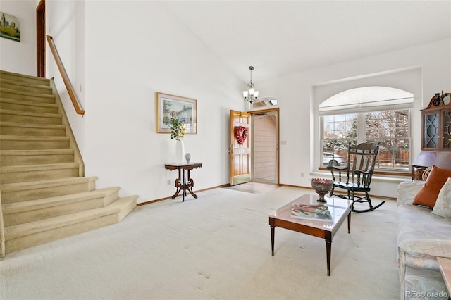 carpeted living room featuring a notable chandelier and high vaulted ceiling