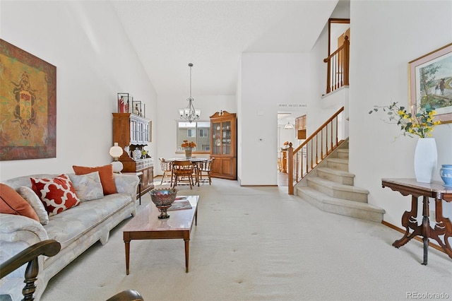 living room with light carpet, high vaulted ceiling, and an inviting chandelier