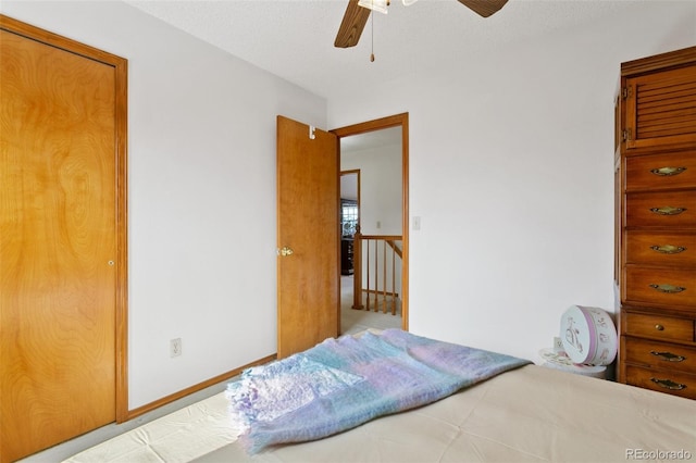 bedroom featuring ceiling fan and a textured ceiling