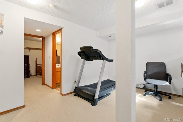 workout area with carpet and a textured ceiling