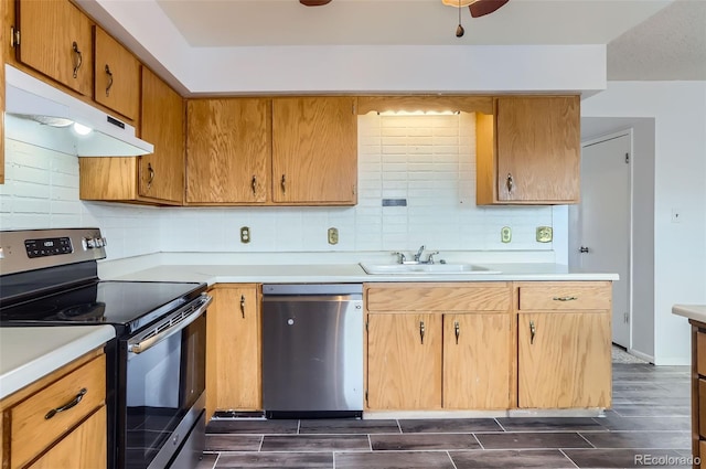 8613 Santa Fe Dr, Thornton, CO 80260 - kitchen with stainless steel appliances, under cabinet range hood, and light countertops