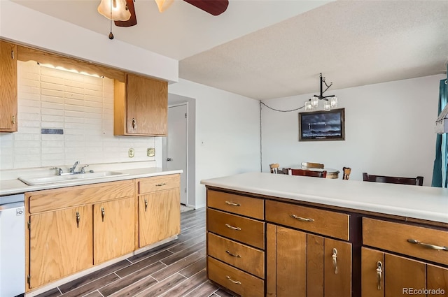 8613 Santa Fe Dr, Thornton, CO 80260 - kitchen featuring a ceiling fan, white dishwasher, light countertops, dark wood-style flooring, and tasteful backsplash