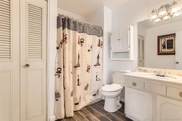 8613 Santa Fe Dr, Thornton, CO 80260 - bathroom with a closet, vanity, wood tiled floors, and a shower with shower curtain