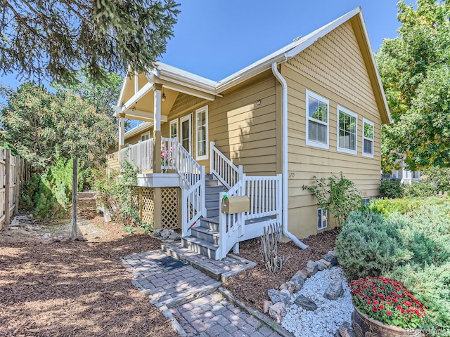 view of side of home with a porch