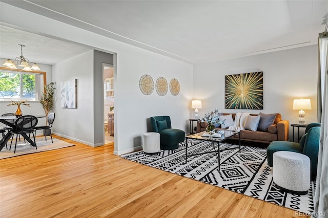 5920 Garrison St, Arvada, CO 80004 - living room featuring wood finished floors, a chandelier, and baseboards