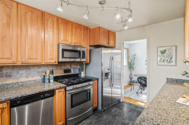 5920 Garrison St, Arvada, CO 80004 - kitchen featuring stainless steel appliances, light stone counters, and decorative backsplash
