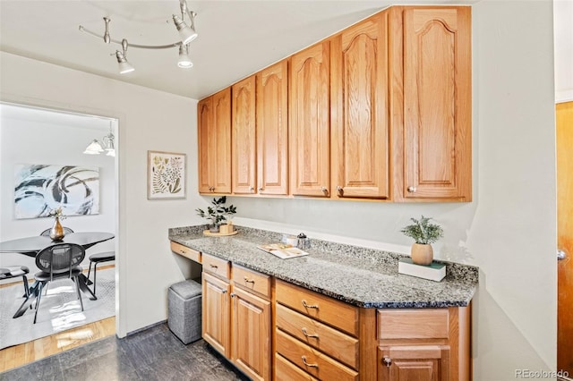 5920 Garrison St, Arvada, CO 80004 - kitchen with dark wood finished floors, dark stone counters, and baseboards