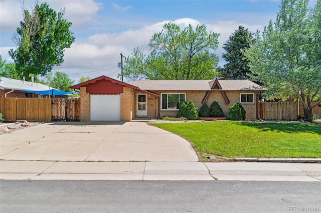 5920 Garrison St, Arvada, CO 80004 - ranch-style home with an attached garage, concrete driveway, and brick siding