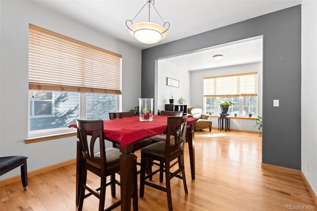 dining room with light wood finished floors and baseboards