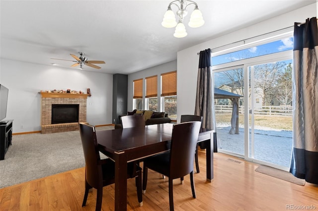 dining space with baseboards, light wood-style floors, and a healthy amount of sunlight